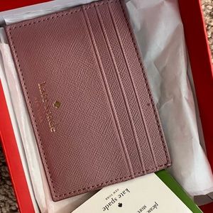 Kate spade card holder with one tiny pink stain. Brand new perfect gift.